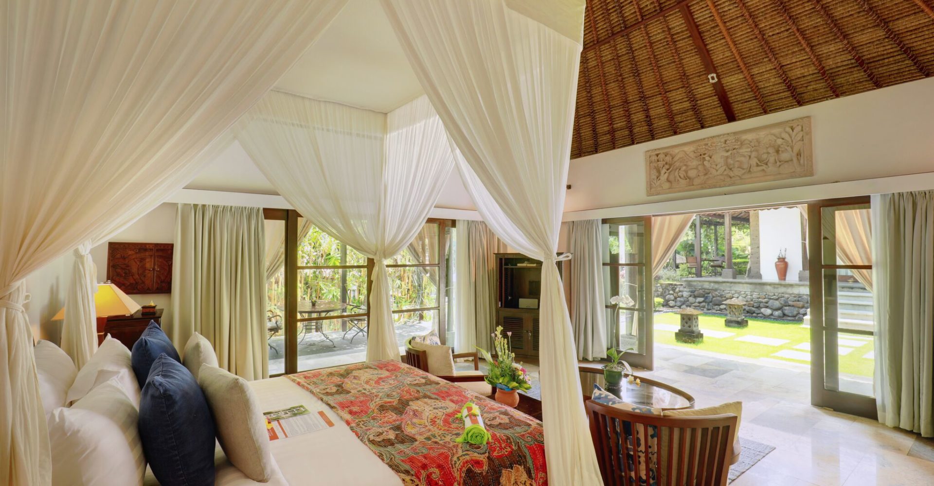 The inside Sukavati's one bedroom luxury villa ‘Samanthabha' with large bed and seating area.