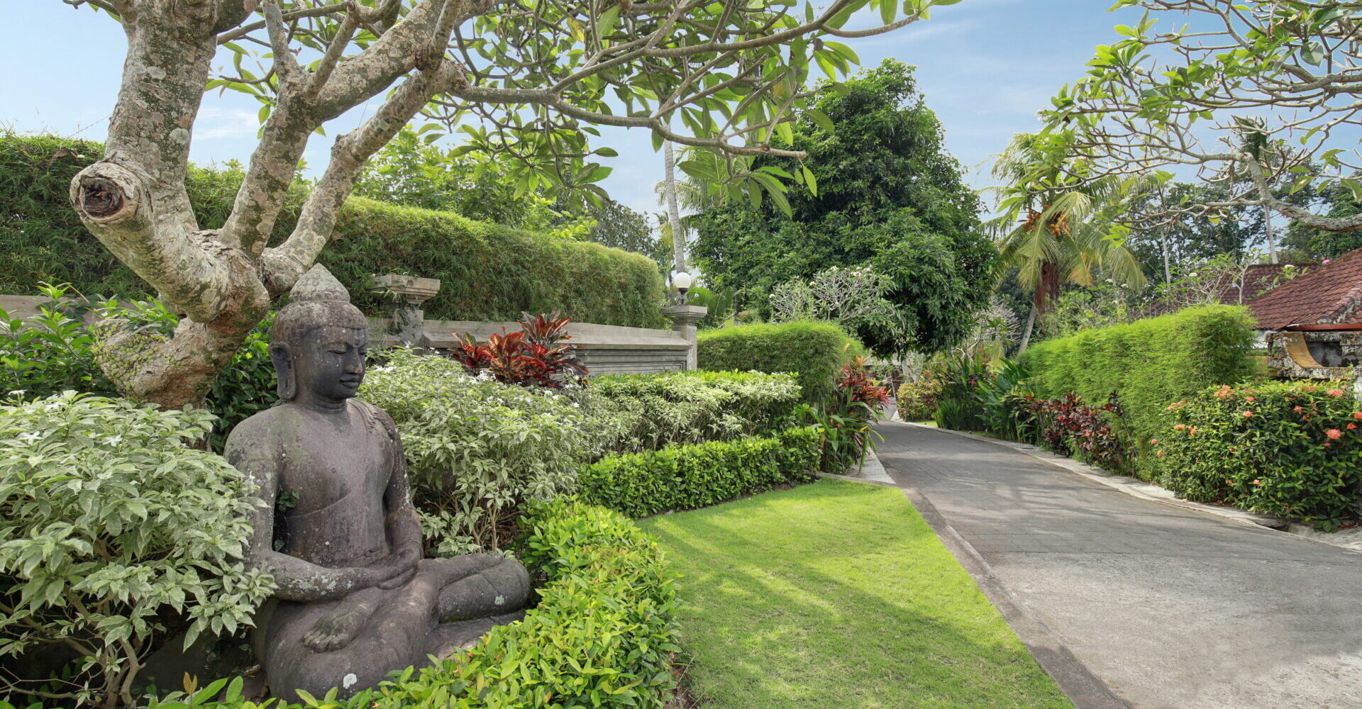 Statue of Buddha in the driveway gardens leading into the Sukavati estate.