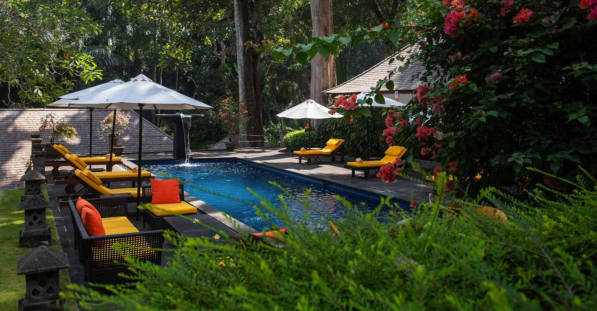 Luxury seating around the tranquil poolside area.