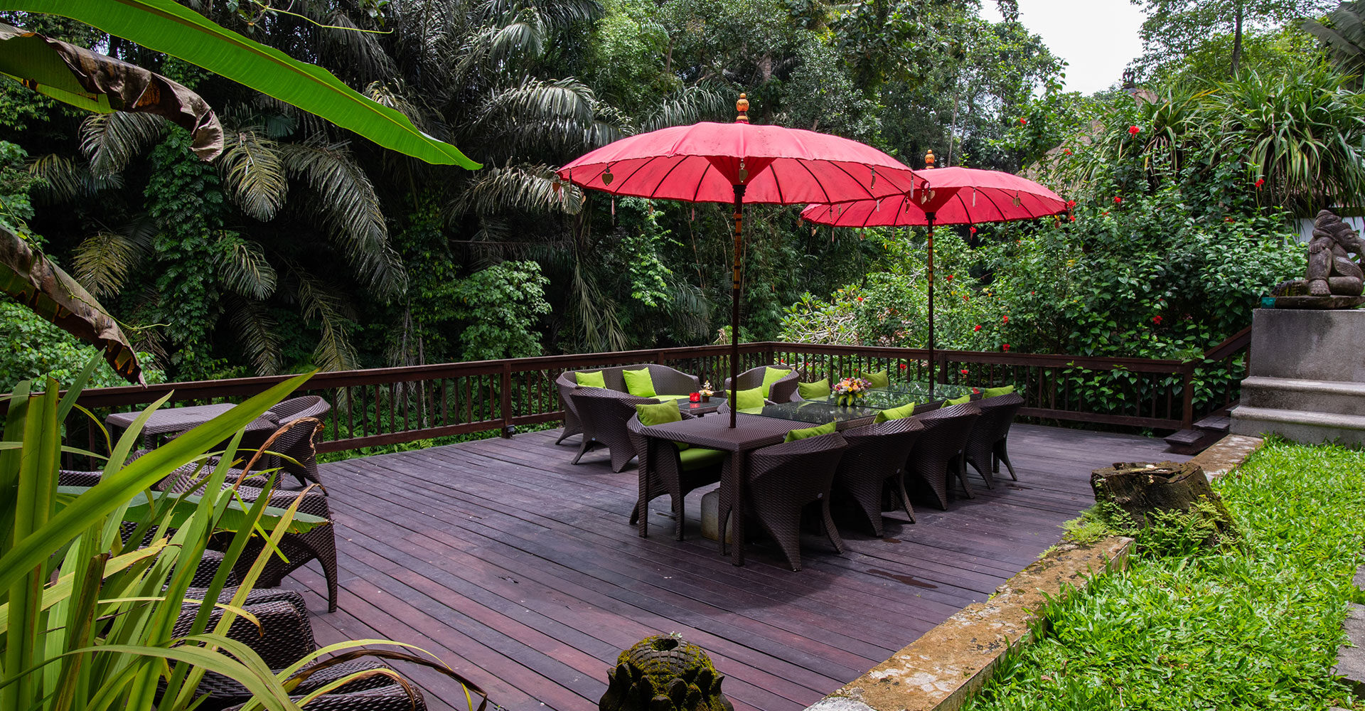One of the decked seating areas under umbrellas on the estate at Sukhavati Ayurvedic Wellness Retreat in Bali overlooking the rainforest.